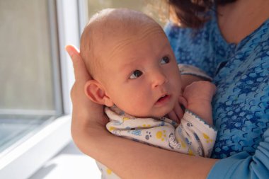 Annem yeni doğmuş bir çocuğun ellerinde tutuyor. İnsanlar