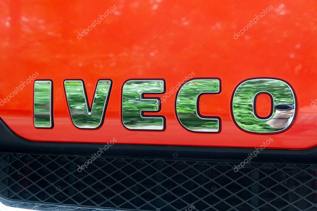 Kyiv, Ukraine - June 11, 2021: Side view of IVECO logotype insignia logo on the front part at the industrial exhibition