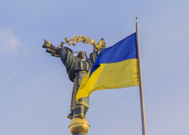 The Independence monument and ukrainian flag in Kiev clipart