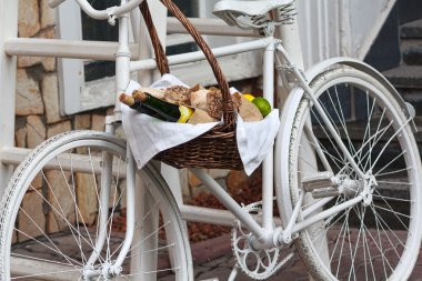 Old bicycle and wicker fruit basket. Decoration clipart