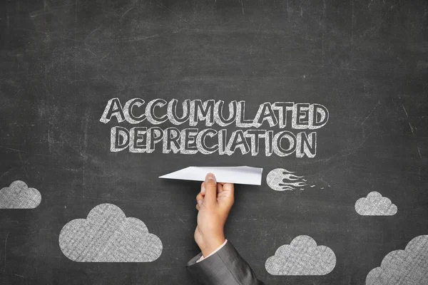 Accumulated depreciation concept on blackboard with paper plane — Stock Photo, Image