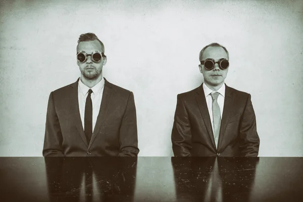 Two businessman sitting at office desk — Stock Photo, Image