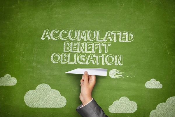 Accumulated benefit obligation concept on blackboard with paper plane — Stock Photo, Image