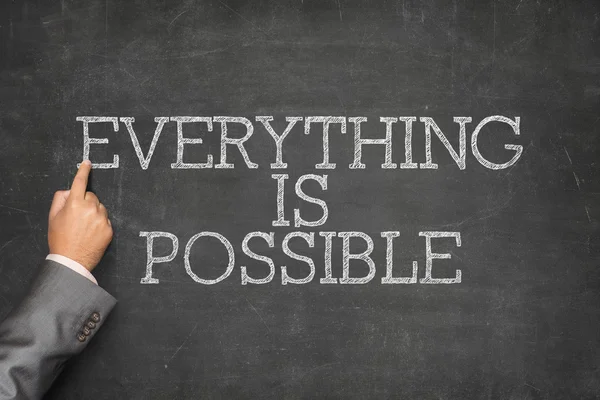 Everything is Possible text on blackboard with businessman hand pointing — Stock Photo, Image