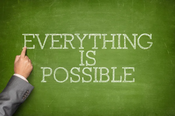Everything is Possible text on blackboard with businessman hand pointing — Stock Photo, Image