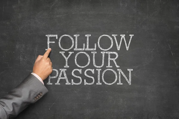 Follow Your Passion text on blackboard with businessman hand pointing — Stock Photo, Image