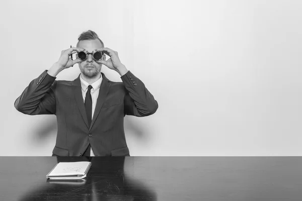 Businessman sitting at office desk with notepad — Stock Photo, Image