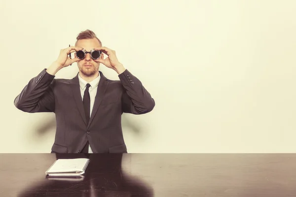 Businessman sitting at office desk with notepad — Stock Photo, Image