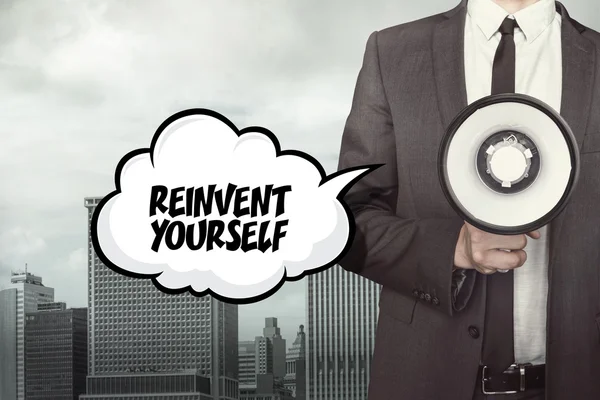 Reinvent yourself text on speech bubble with businessman — Stock Photo, Image