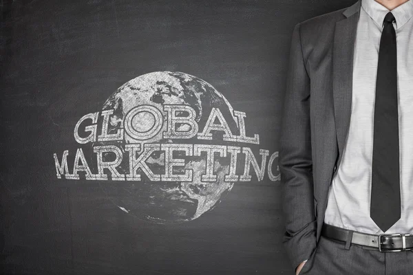Global marketing concept on blackboard — Stock Photo, Image