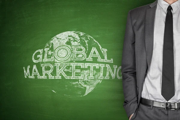 Global marketing concept on blackboard — Stock Photo, Image