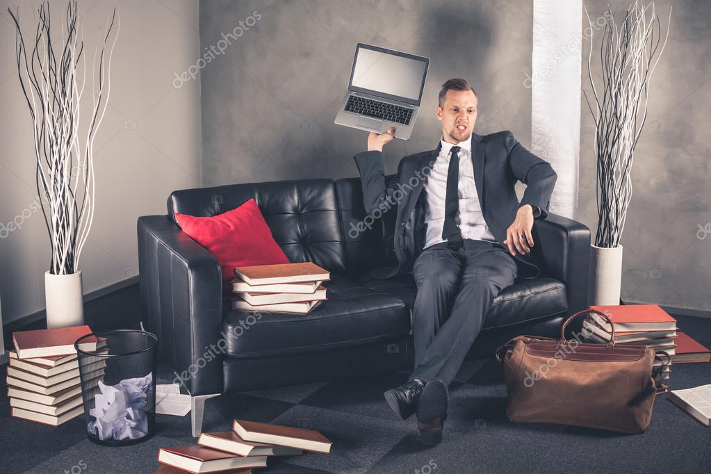 Businessman throws laptop — Stock Photo © infocrashmedia.fi 58189173