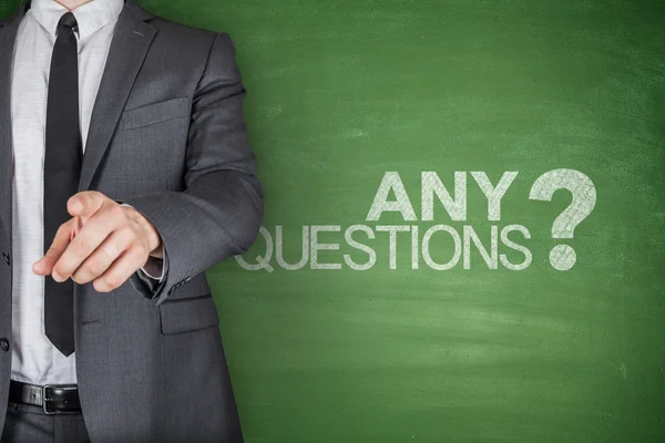 Any Questions concept on green Blackboard — Stock Photo, Image