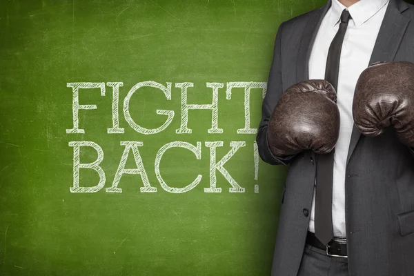 Fight back on blackboard with businessman — Stock Photo, Image