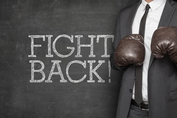 Fight back on blackboard with businessman — Stock Photo, Image