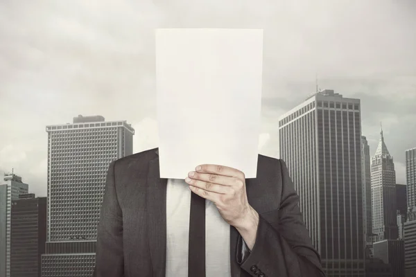 Empresário segurando papel vazio na frente dele — Fotografia de Stock