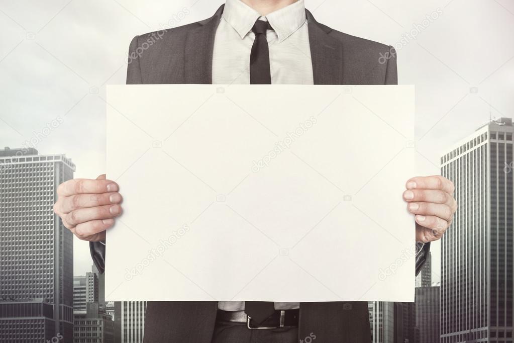 Businessman holding empty paper front of him