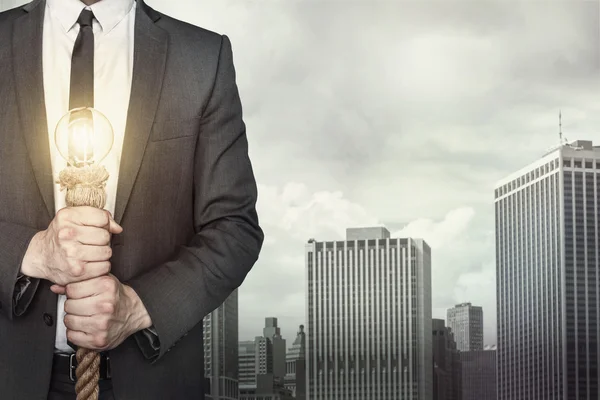 Businessman with light bulb — Stock Photo, Image