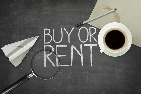 Buy or rent concept on black blackboard with empty paper sheet — Stock Photo, Image