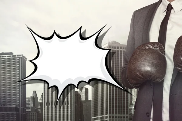 Empty speech bubble with businessman wearing boxing gloves — Stock Photo, Image