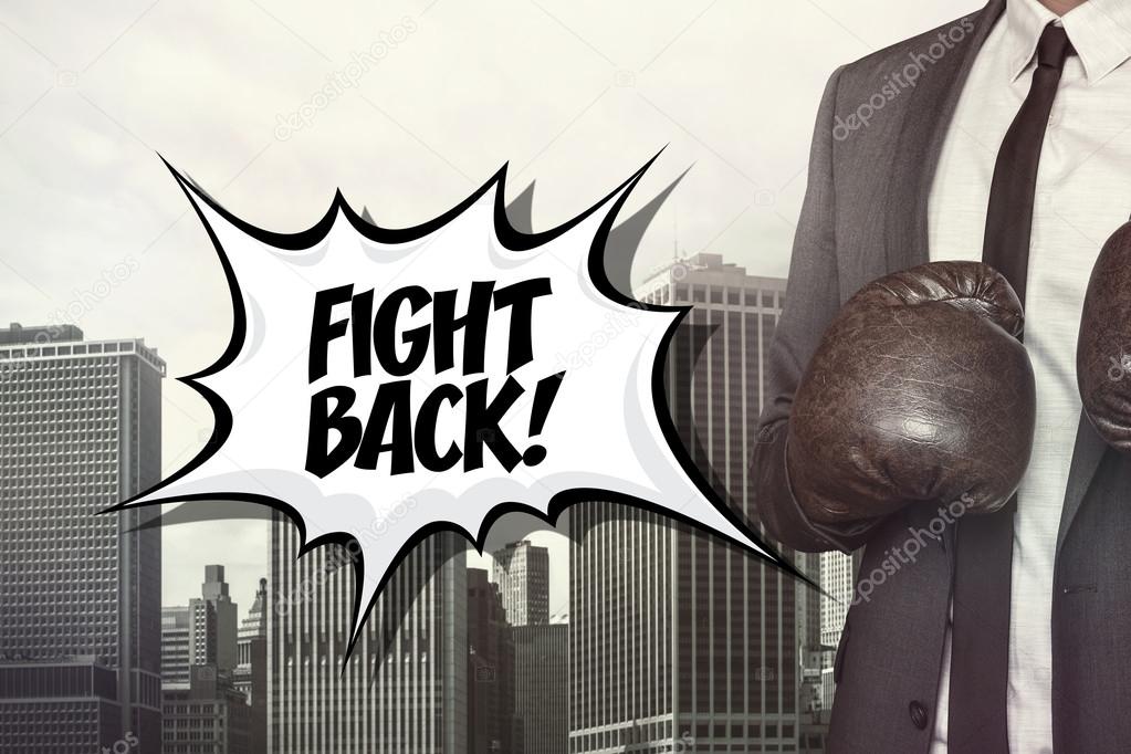Fight back text with businessman wearing boxing gloves