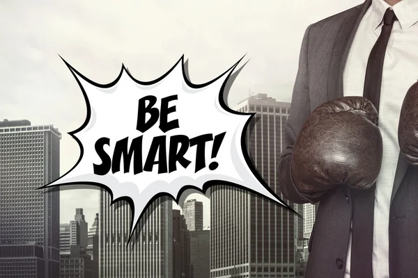 Be smart text with businessman wearing boxing gloves — Stock Photo, Image