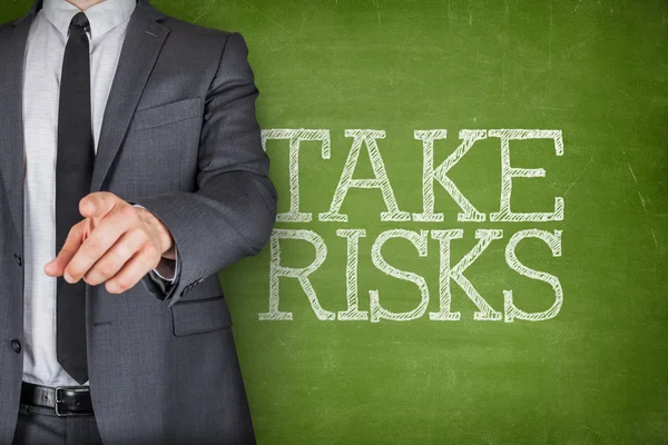 Take risks on blackboard with businessman — Stock Photo, Image