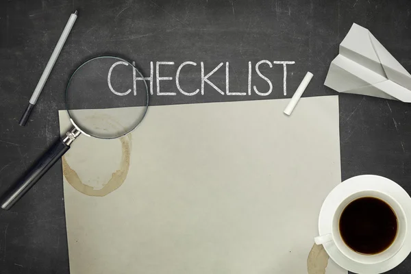 Checklist concept on black blackboard with empty paper sheet — Stock Photo, Image