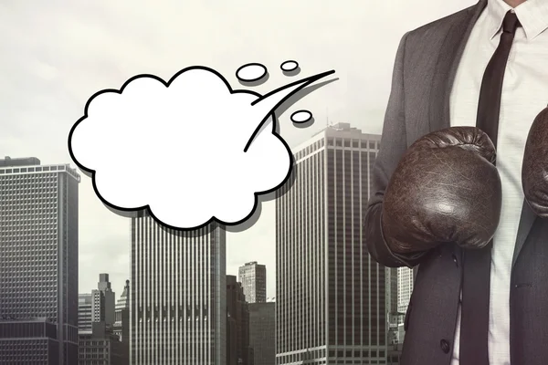 Empty speech bubble with businessman wearing boxing gloves — Stock Photo, Image