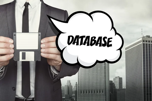 -Databasetekst op tekstballon met zakenman houden van diskette — Stockfoto