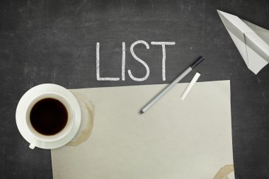 List concept on black blackboard with empty paper sheet clipart