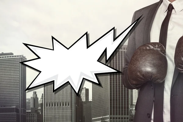 Empty speech bubble with businessman wearing boxing gloves — Stock Photo, Image