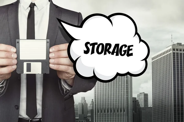 Storage text on speech bubble with businessman holding diskette — Stock Photo, Image