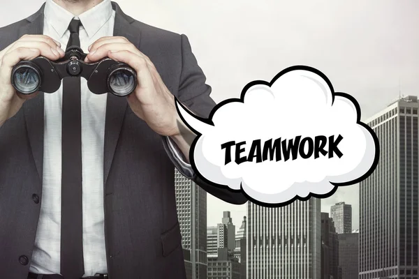 Teamwork text on speech bubble with businessman holding binoculars — Stock Photo, Image