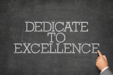Dedicate to excellence text on blackboard clipart