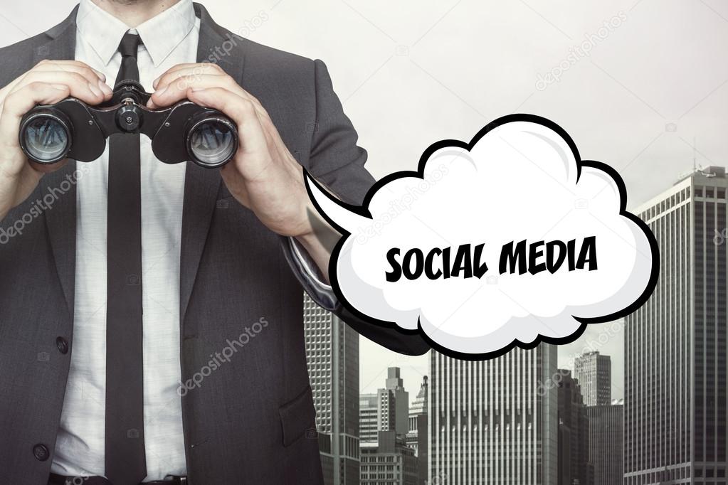 Social media text on speech bubble with businessman holding binoculars