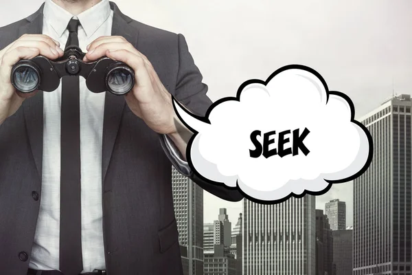 Seek text on speech bubble with businessman holding binoculars — Stock Photo, Image
