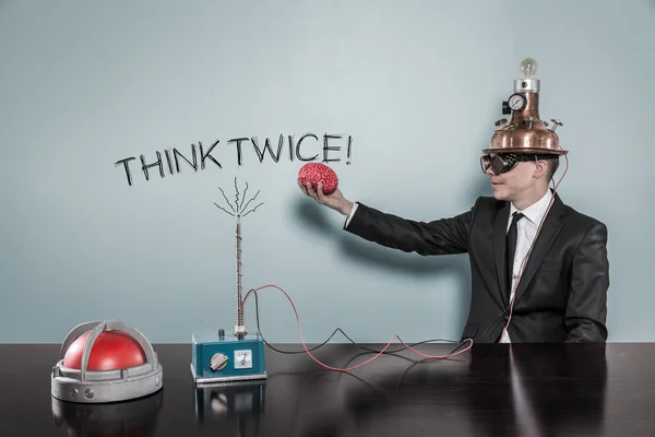 Think twice concept with businessman holding brain — Stock Photo, Image