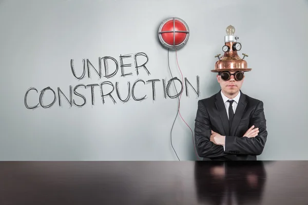 Under construction text with alert light and vintage businessman — Stock Photo, Image