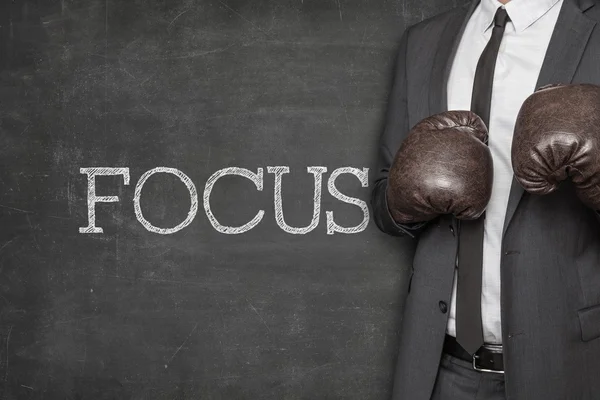 Focus on blackboard with businessman on side — Stock Photo, Image