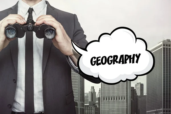 Geography text on speech bubble with businessman holding binoculars — Stock Photo, Image