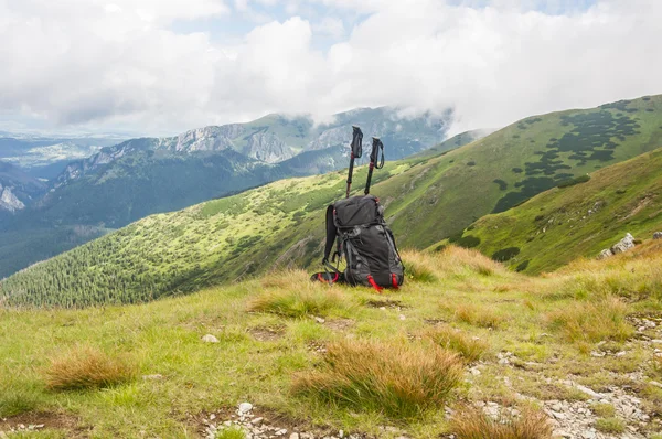Backpack and trekking poles — Stock Photo, Image