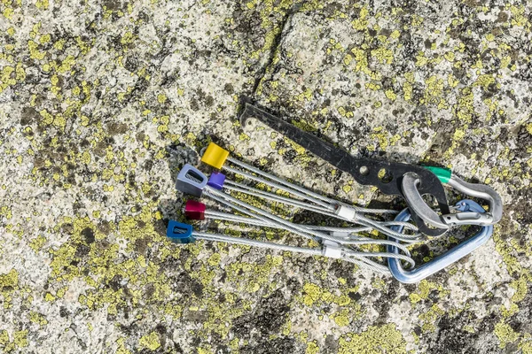 Set of nuts and a nut removal tool on the rock — Stock Photo, Image