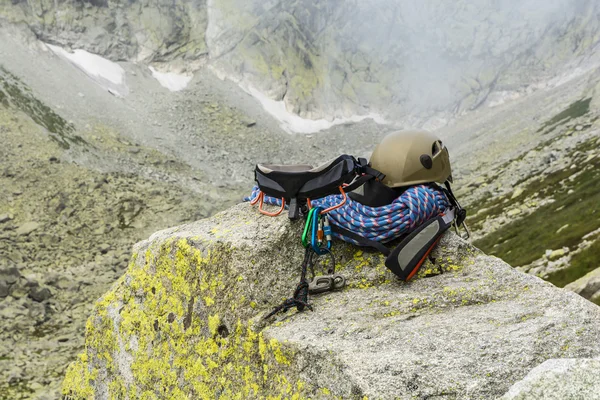 Corda dinamica, casco, moschettoni, imbracatura da arrampicata e discensore sulla roccia — Foto Stock