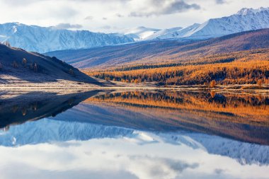 Reflection of mountains in a mountain lake in autumn, Altai, background