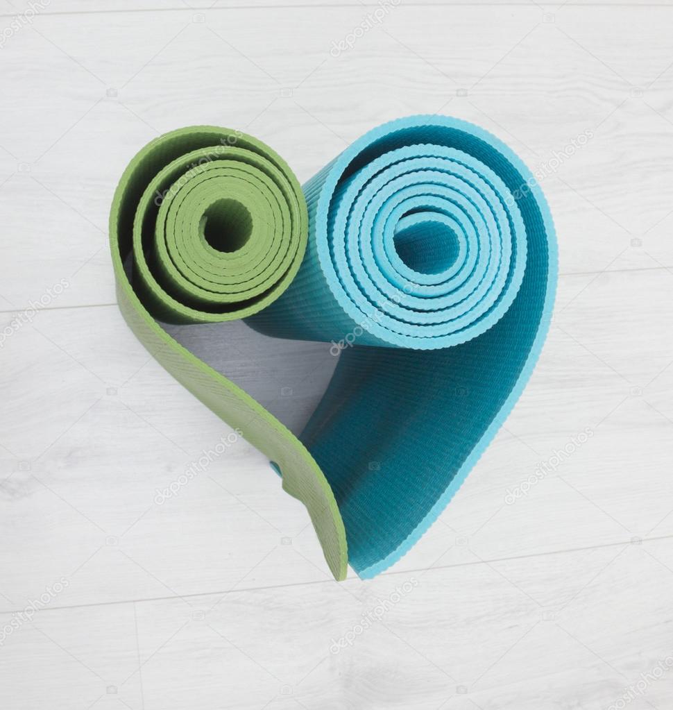 two yoga mats stacked in the shape of heart