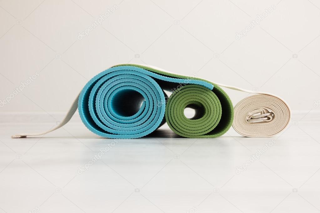 two yoga mats and  belt