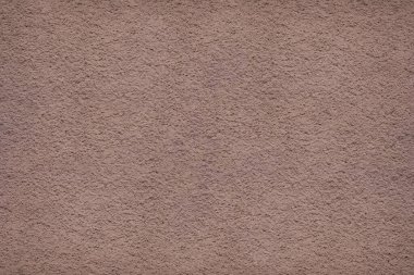 Koyu pembe akrilik alçı dokusu. Yeni sıvanmış bir duvarın yakın çekimi.