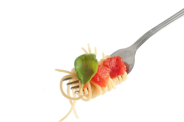 Spaghetti with fresh tomato rolled on fork. Traditional Italian Royalty Free Stock Images