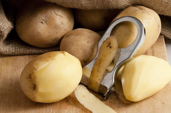 Potatoes outside a jute sack Stock Image